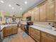 Bright kitchen featuring wood cabinets, marble countertops, stainless steel appliances, and views to dining area at 4081 Dunmore Dr, Lake Wales, FL 33859