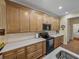 Bright kitchen featuring wood cabinets, marble countertops, and stainless steel appliances at 4081 Dunmore Dr, Lake Wales, FL 33859