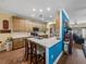Bright kitchen featuring wood cabinets, marble countertops, an island with seating, and stainless steel appliances at 4081 Dunmore Dr, Lake Wales, FL 33859