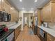 Spacious kitchen with wood cabinets, marble countertops, stainless steel appliances, and wood-look flooring at 4081 Dunmore Dr, Lake Wales, FL 33859