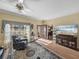 Bright living room with comfortable seating, large windows, and a seamless transition to the office at 4081 Dunmore Dr, Lake Wales, FL 33859