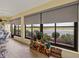 Inviting sunroom with tile flooring, large windows offering scenic views, and cozy seating, perfect for relaxation at 4081 Dunmore Dr, Lake Wales, FL 33859