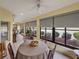 Bright and airy sunroom with lake view, stylish seating, and tile floors, perfect for relaxing and entertaining at 4081 Dunmore Dr, Lake Wales, FL 33859