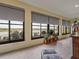 Bright sunroom featuring large windows with scenic lake views and stylish decor creating a serene and inviting atmosphere at 4081 Dunmore Dr, Lake Wales, FL 33859