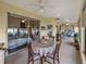 Bright sunroom featuring a dining area, comfortable seating, and serene views of the surrounding landscape at 4081 Dunmore Dr, Lake Wales, FL 33859