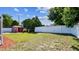Back yard with an outbuilding, green grass, and a privacy fence, creating an outdoor retreat at 419 Broward Ter, Winter Haven, FL 33884