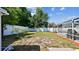 Back yard with green grass, a privacy fence, and access to a screened-in pool area at 419 Broward Ter, Winter Haven, FL 33884