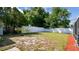 Back yard featuring green grass, a white fence, and mature trees, offering privacy at 419 Broward Ter, Winter Haven, FL 33884