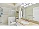Well-lit bathroom with granite vanity, glass block accent, and walk-in shower at 419 Broward Ter, Winter Haven, FL 33884