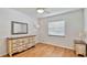 Bedroom with light walls, wood floors, and natural light at 419 Broward Ter, Winter Haven, FL 33884