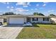 Charming single-story home features a brick facade, attached garage, and well-maintained front yard at 419 Broward Ter, Winter Haven, FL 33884