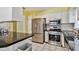 Eat-in kitchen with stainless steel appliances, white cabinets, and black countertop at 419 Broward Ter, Winter Haven, FL 33884