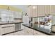 Bright kitchen with white cabinets, black countertops, and stainless-steel appliances at 419 Broward Ter, Winter Haven, FL 33884