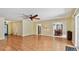 Large living room with hardwood floors, ceiling fan, and view to front door at 419 Broward Ter, Winter Haven, FL 33884