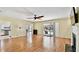 Open living room with hardwood floors, fireplace, and sliding glass doors to a patio and pool at 419 Broward Ter, Winter Haven, FL 33884