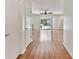 Open living space with wood floors and slider door to lanai and pool at 419 Broward Ter, Winter Haven, FL 33884
