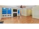 Bright living room features a fireplace, custom shelving and hardwood flooring at 419 Broward Ter, Winter Haven, FL 33884