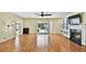 Bright living room with wood floors, fireplace, built-in shelves, and sliding doors to the pool area at 419 Broward Ter, Winter Haven, FL 33884