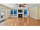 Spacious living room with hardwood floors, fireplace, custom built-ins, and ceiling fan at 419 Broward Ter, Winter Haven, FL 33884