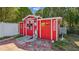 Red outbuilding with vintage-style decor, providing additional storage or workspace at 419 Broward Ter, Winter Haven, FL 33884