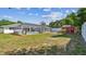 Backyard featuring a large screened in pool with an outdoor shed and privacy fence at 419 Broward Ter, Winter Haven, FL 33884
