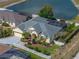 Aerial view of the home's exterior showcasing landscaping, screened pool and access to a large body of water at 428 Terranova St, Winter Haven, FL 33884