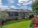 Beautiful backyard featuring a screened pool and vibrant landscaping creates a tranquil outdoor oasis at 428 Terranova St, Winter Haven, FL 33884
