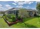 Lush backyard showcasing a screened pool area with beautiful landscaping offers a serene retreat at 428 Terranova St, Winter Haven, FL 33884