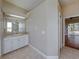 Bright bathroom features a white vanity and tile floor, with views to the backyard at 428 Terranova St, Winter Haven, FL 33884