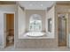 Bright bathroom with a large soaking tub, tiled shower and updated fixtures at 428 Terranova St, Winter Haven, FL 33884