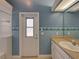 Bathroom with light blue walls, door, vanity, and dolphin border at 428 Terranova St, Winter Haven, FL 33884