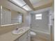 Bathroom features a vanity with white cabinets and a bathtub with tile surround at 428 Terranova St, Winter Haven, FL 33884