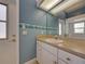 Bathroom features blue walls, vanity, sink, mirror, and ocean border at 428 Terranova St, Winter Haven, FL 33884