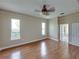 Cozy bedroom with hardwood floors, two windows, a ceiling fan, and plenty of natural light at 428 Terranova St, Winter Haven, FL 33884