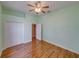 Bright bedroom featuring wood-look floors, a ceiling fan, and closet space at 428 Terranova St, Winter Haven, FL 33884