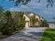 Inviting single Gathering home featuring a well manicured front yard and a spacious driveway leading to an attached garage at 428 Terranova St, Winter Haven, FL 33884