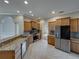 Spacious kitchen with stainless steel appliances, granite countertops, tile floors, and ample cabinet space at 428 Terranova St, Winter Haven, FL 33884