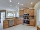 Well-lit kitchen showcasing granite countertops, stainless steel appliances, tile backsplash, and an open design at 428 Terranova St, Winter Haven, FL 33884