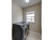 Laundry room with modern washer and dryer units and a window offering natural light at 428 Terranova St, Winter Haven, FL 33884