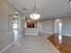 Open-concept living area featuring tile flooring, decorative archways, and ample natural light at 428 Terranova St, Winter Haven, FL 33884