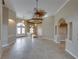 Expansive open-concept living space with tile flooring, arched doorways, and elegant chandeliers, perfect for entertaining and relaxation at 428 Terranova St, Winter Haven, FL 33884