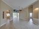 An open-concept living room featuring tile flooring, neutral walls, and sliding glass doors to a pool area for seamless indoor/outdoor living at 428 Terranova St, Winter Haven, FL 33884