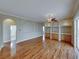 Spacious living room with hardwood floors, custom built-ins, and large sliding glass doors at 428 Terranova St, Winter Haven, FL 33884