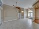 Spacious living room featuring tile floors, neutral paint, a unique ceiling fan, and a decorative arched doorway at 428 Terranova St, Winter Haven, FL 33884