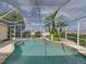 Screened in pool area with a small garden featuring palm trees at 428 Terranova St, Winter Haven, FL 33884