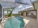 Screened in pool area featuring a garden with palm trees at 428 Terranova St, Winter Haven, FL 33884