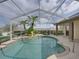 Screened in pool with an exterior garden featuring palm trees at 428 Terranova St, Winter Haven, FL 33884