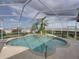 Screened in pool area with a small garden featuring palm trees at 428 Terranova St, Winter Haven, FL 33884
