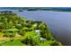 Aerial view showcasing the sprawling property with lush landscaping bordering the serene lakefront at 4365 Canal Rd, Lake Wales, FL 33898