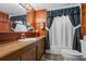 Functional bathroom with wood vanity, mirrored cabinet, and shower-tub combination at 4365 Canal Rd, Lake Wales, FL 33898